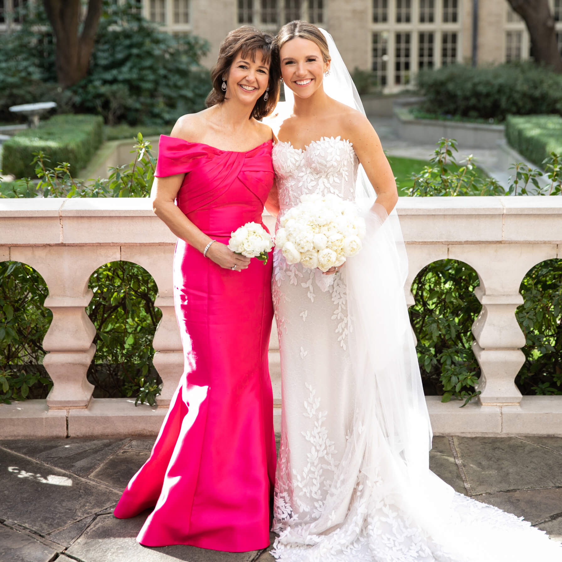 Mother and bride posing together outdoors
