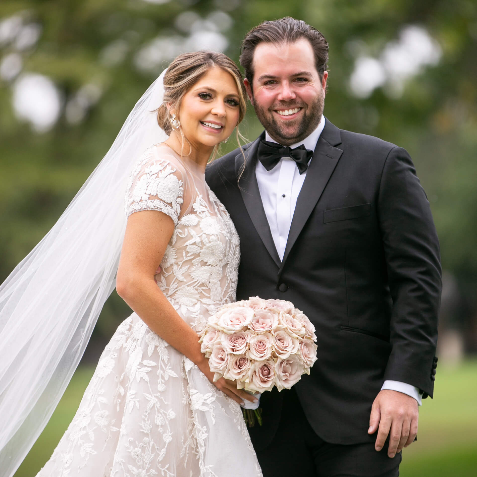 Smiling bride and groom posing for the camera
