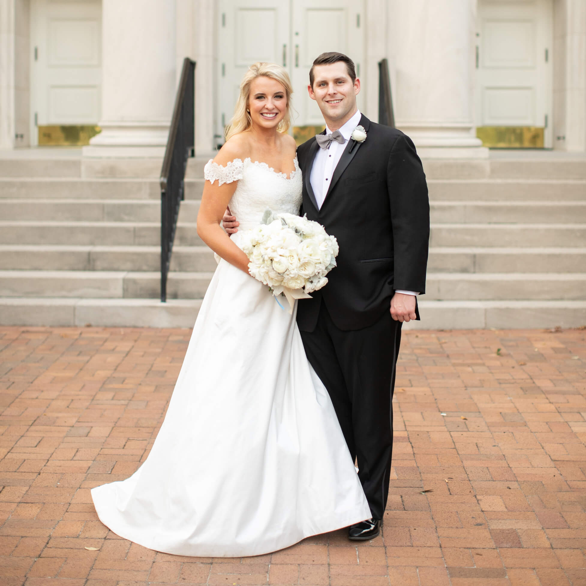 Bride and groom standing in front of stairs before the ceremony