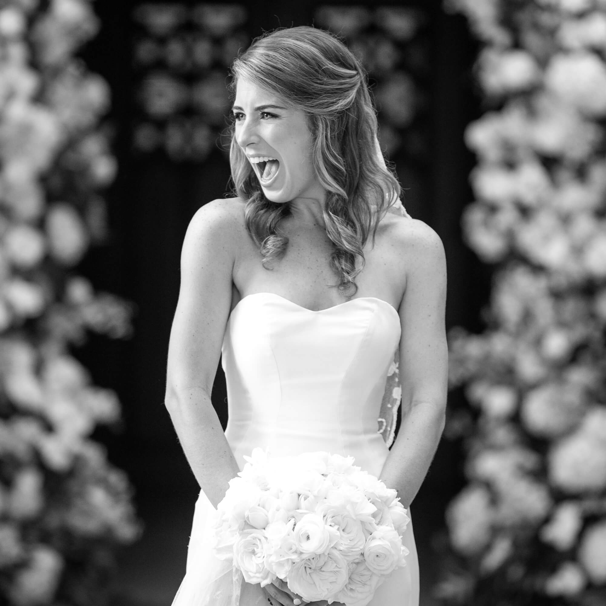Black and white photo of bride smiling for the camera