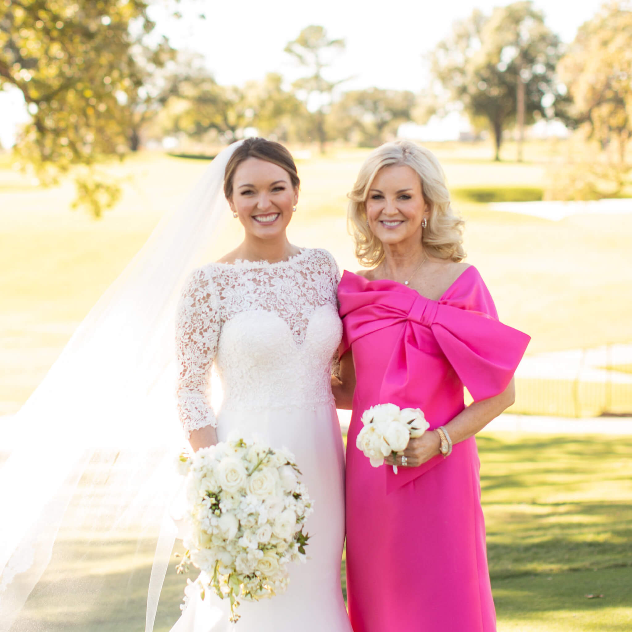 Bride in white, Mother of bride in pink