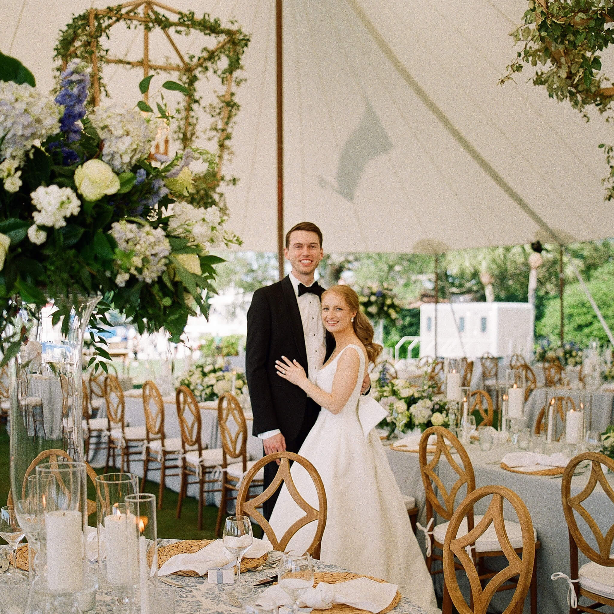 Film photograph of bride and groom posing in reception hall